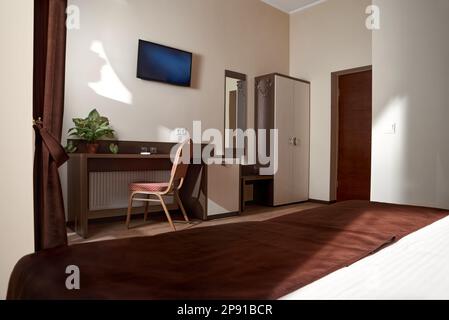Clean white bath towels on the neatly clean bed of hotel room - coziness and clean concept. Mockup Stock Photo