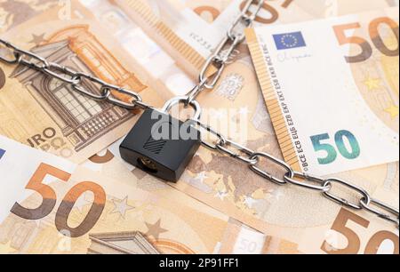 Lock security and chain on euro banknotes background. Monetary crisis, financial problems, sanctions, default concept Stock Photo