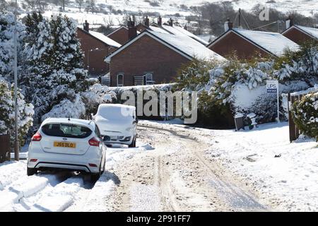 snow covered street in rural area after heavy snowfall overnight in winter newtownabbey northern ireland uk 10th march 2023 Stock Photo