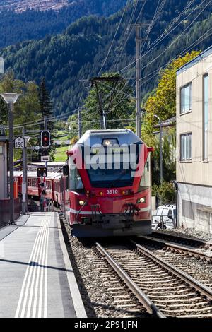 bernina express mountain railway train entering poschiavo station Stock Photo