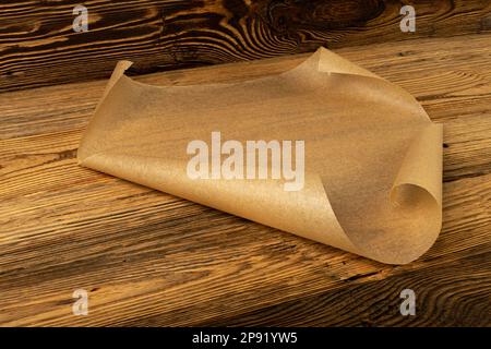 Roll of brown parchment paper for baking food in female hands