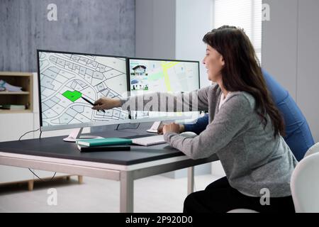 Developer Looking At Land Plot Map And Cadastre Plan Stock Photo