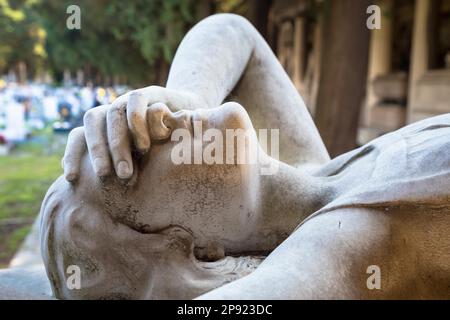 GENOA, ITALY - June 2020: antique statue of angel (1910) (marble) in a Christian Catholic cemetery - Italy Stock Photo