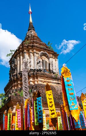 Ancient pagoda with the zodiac flags at Wat Lok Molee in Chiang Mai province Thailand Stock Photo