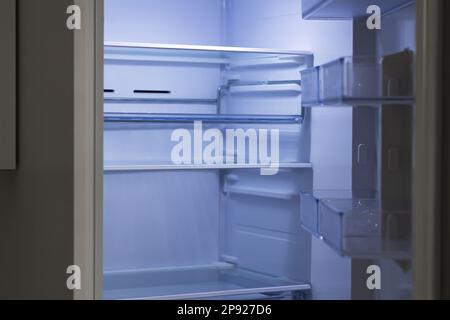 Open fridge with empty shelves, clean after defrosting refrigerator Stock Photo