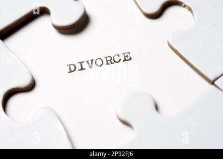 Divorce intelligence text written with a typewriter in a white puzzle Stock Photo