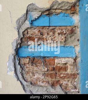damaged masonry wall reinforced with structural steel bracing Stock Photo