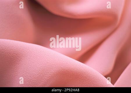 Delicate pale pink thin fabric, beige material chiffon waves. Stock Photo