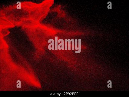 Red dust particles explosioon on black background.Red powder splash. Stock Photo