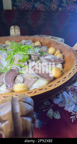 Kazakh traditional dish beshbarmak on the table. Stock Photo