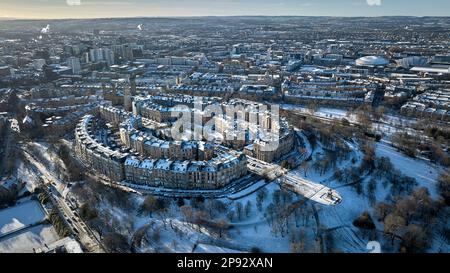 Aerial shot of Park Circus and Kelvingrove Park looking SW across to OVO Hydro BBC Scotland and Finneston on a snowy spring morning. Stock Photo