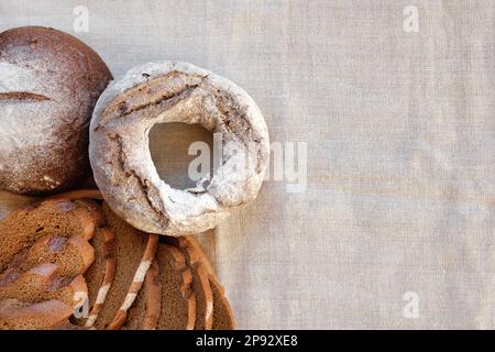 Baked bread. Loaf of Bread. Fresh Bakery Products on Wooden Board. Healthy Food Concept. Top View. Flat lay. Slices of Homemade Sourdough Bread with F Stock Photo