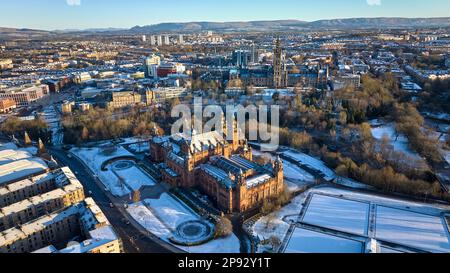 Aerial view of University of Glasgow and Kelvingrove Art Gallery and Museum from above Kelvingrove Park on a snowy spring morning. Stock Photo
