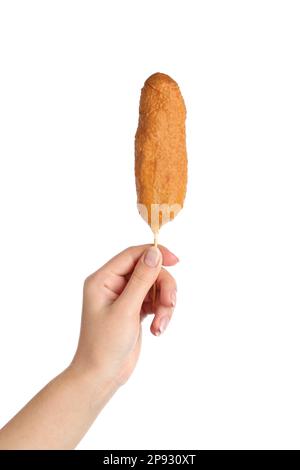 Woman holding delicious deep fried corn dog on white background, closeup Stock Photo