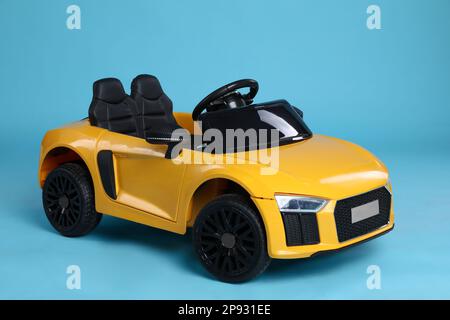 Toy yellow car on light blue background Stock Photo