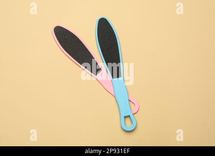 Colorful foot files on beige background, flat lay. Pedicure tools Stock Photo