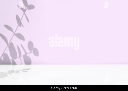 Plant shadows on violet color wall. Leaves shadow background. Branches, flowers and foliage on pastel studio background. Product presentation, Minimal Stock Photo