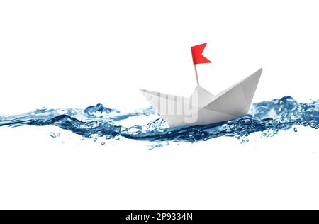 Handmade paper boat floating on clear water against white background Stock Photo