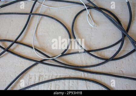 Messy pile of cables on the screed Stock Photo