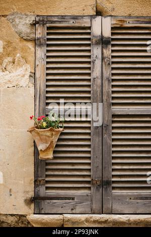 Shuttered wooden window store in the old town of Pollença in Mallorca, Spain. Stock Photo