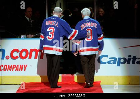 Andy Bathgate, right, of the New York Rangers recovers the puck