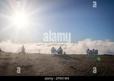 Several people admire the sunset on the top of Haleakala, Haleakala National Park, Maui, Hawaii, USA, Polynesia, Oceania Stock Photo