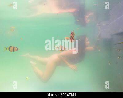 North America, Caribbean, Greater Antilles, Hispaniola Island, Dominican Republic, Sama, woman diving in the natural pool of the Hotel Hacienda Cocuyo in Sama Stock Photo