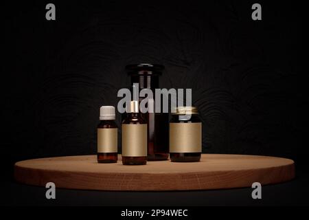Wooden podium on dark background with pharmaceutical, cosmetic bottles. Premium empty stage for product promotion, beauty, natural eco cosmetic. Showc Stock Photo