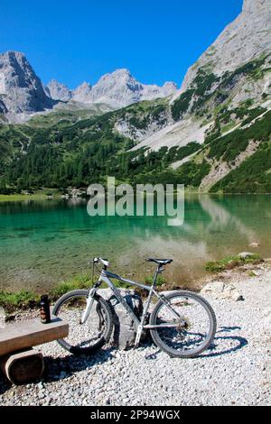 Austria, Tyrol, Ehrwald, Seebensee, bicycle, water surface, lake, mountain lake, mountain landscape, mountain massif, Stock Photo