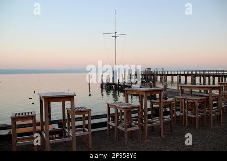 Boat dock, jetty, boardwalk in the sunrise at the lakeside, Holzhausen, Ammersee, Voralpensee, Alpenvorland, Upper Bavaria, Bavaria, Germany Stock Photo