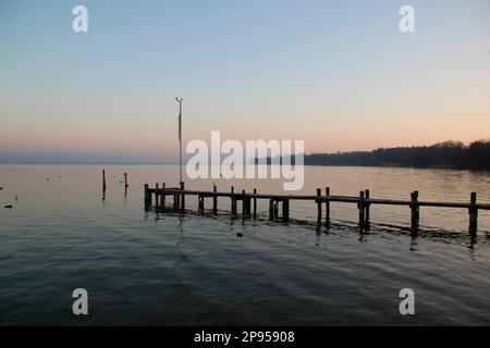 Boat dock, jetty, boardwalk in the sunrise at the lakeside, Holzhausen, Ammersee, Voralpensee, Alpenvorland, Upper Bavaria, Bavaria, Germany Stock Photo
