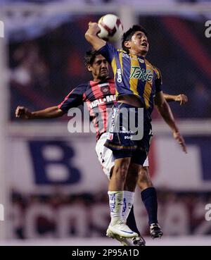 San Lorenzo de Alamgro's Adrian Gonzalez, right, fights for the ball with  Lanus' Sebastian Blanco during an Argentinean first division soccer match  in Buenos Aires, Saturday, Nov. 22, 2008. (AP Photo/Daniel Luna