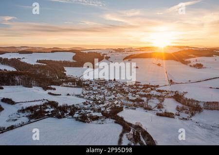 Germany, Thuringia, Allendorf, village, forests, landscape, snow, sunset, overview, aerial photo, back light Stock Photo