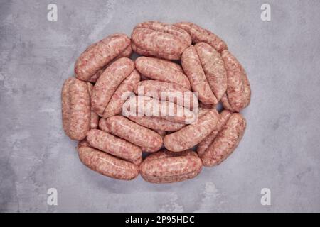 Overhead shot of pile of sausages on background in butchers shop Stock Photo
