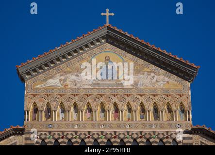 Detail of top of the facade of Duomo di Sant Andrea (St Andrew's cathedral). Amalfi, Salerno, Italy  Amalfi Coast. Begun in the 9th and 10th centuries, the cathedral has been added to and redecorated several times, overlaying Arab-Norman, Gothic, Renaissance, Baroque elements, and finally a new 19th century Norman-Arab-Byzantine facade. Stock Photo