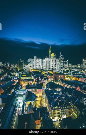 View from cathedral in Frankfurt am Main, on the illuminated city and its streets. From the old town, Römerberg, Paulskirche to the illuminated skyline. Stock Photo