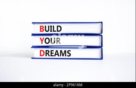 BYD build your dreams symbol. Concept words BYD build your dreams on books on a beautiful white table white background. Business and BYD build your dr Stock Photo