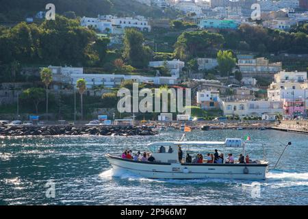 Approaching Capri harbour by boat. Capri is an island located in the Tyrrhenian Sea off the Sorrento Peninsula, on the south side of the Gulf of Naples in theCampaniaregion of Italy  Capri, is famed for its rugged landscape, cultural history, upscale hotels and shopping Stock Photo