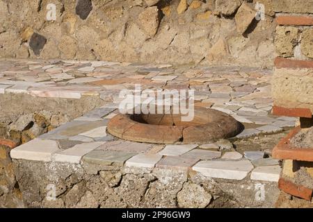 Herculaneum uncovered. Herculaneum was buried under volcanic ash and pumice in the eruption of Mount Vesuvius in AD 79. Ercolano, Campania, Italy . Remains of a shop sellingfrom large ceramic pots. Stock Photo