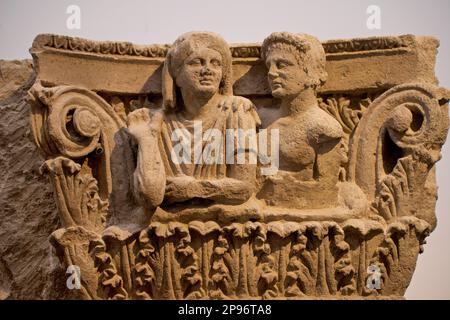 Ornately carved Roman tufa stone capital from Pompeii depicting married couple. Second half of second century BCE.   Pompeii's Antiquarium first opened in 1873, but closed in 1980, only reopening as a museum again with a permanent display of artefacts in 2021. Pompeii, Naples, Italy Stock Photo