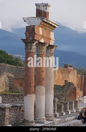 Reconstructed freestanding Corinthian columns in the Forum, Pompeii, near Naples, Italy  Fluted stucco and brick interior. Stock Photo