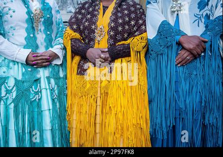 Detail of dresses and hands. At left Benita la Intocable , in the middle Angela la Folclorista, and at right Dina, cholitas females wrestlers, El Alto Stock Photo