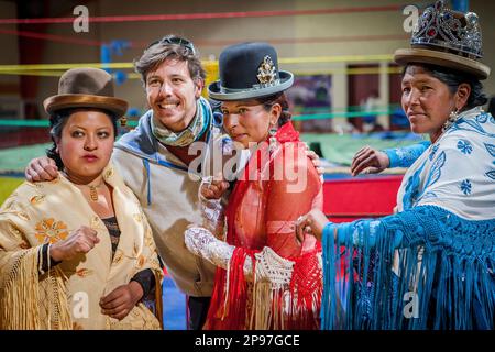 Lucha Libre. After the show. A follower is photographed with cholitas fighters. At left Julieta, in the middle Celia la Simpatica, and Dina , cholitas Stock Photo