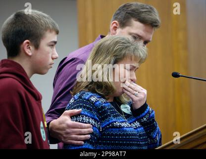 James Brodie left age 14 stands by his parents as his father