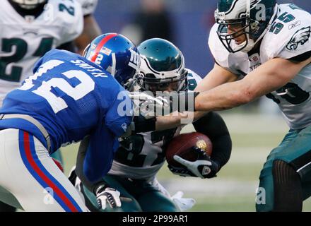 Philadelphia Eagles Joselio Hanson (21) and Stewart Bradley (55) celebrate  an interception by teammate Quintin Mikell (27) against the New York Giants  in the fourth quarter of an NFC Divisional Playoff game.