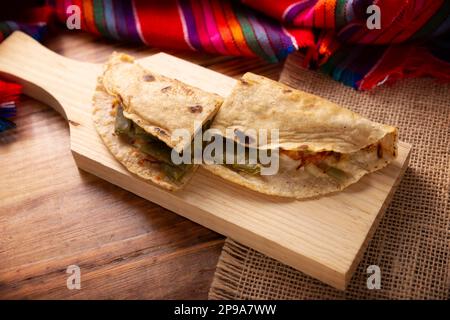 Quesadilla de Comal con queso y Nopales. Typical Mexican quesadilla made on a comal, very popular dish, one of the main street food in Mexico. Table t Stock Photo