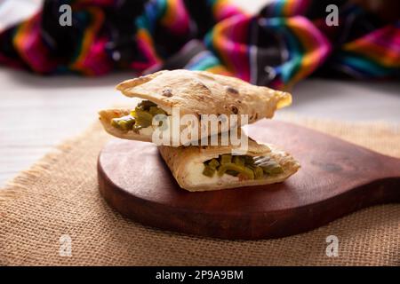 Quesadilla de Comal con queso y Nopales. Typical Mexican quesadilla made on a comal, very popular dish, one of the main street food in Mexico. Stock Photo