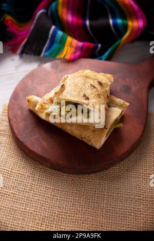 Quesadilla de Comal con queso y Nopales. Typical Mexican quesadilla made on a comal, very popular dish, one of the main street food in Mexico. Stock Photo