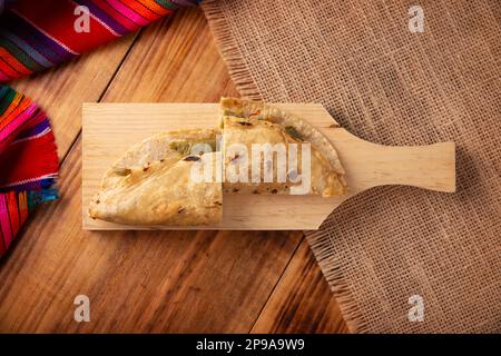 Quesadilla de Comal con queso y Nopales. Typical Mexican quesadilla made on a comal, very popular dish, one of the main street food in Mexico. Table t Stock Photo