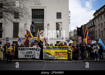 London, UK. 10th Mar, 2023. Protesters hold Tibetan flags and banners on the Tibetan National Uprising Day. Hundreds of Tibetans residing in London marched from Downing Street to the Embassy of China in London on the 64th anniversary of the Tibetan National Uprising Day. The march commemorates tens of thousands of Tibetans rising up against China's illegal invasion and occupation of their homeland on 10th March 1959. Credit: SOPA Images Limited/Alamy Live News Stock Photo